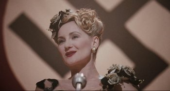 Movie still from “Valkyrie” (2008), directed by Bryan Singer – A woman in a black and white dress with flowers in her hair; Close Up shot, Low angle