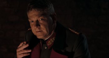 Movie still from “Valkyrie” (2008), directed by Bryan Singer – A person wearing a military uniform; Close Up shot, Over the shoulder angle