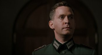 Movie still from “Valkyrie” (2008), directed by Bryan Singer – A person wearing a military uniform; Close Up shot, Low angle