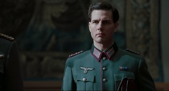 Movie still from “Valkyrie” (2008), directed by Bryan Singer – A man in a military uniform stands in front of a painting; Close Up shot, Low angle