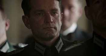 Movie still from “Valkyrie” (2008), directed by Bryan Singer – A person wearing a military uniform; Close Up shot, Low angle