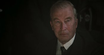 Movie still from “Valkyrie” (2008), directed by Bryan Singer – An older man wearing a suit and tie; Close Up shot, Low angle
