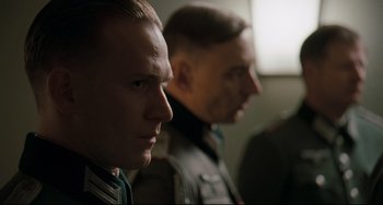 Movie still from “Valkyrie” (2008), directed by Bryan Singer – Two men in military garb looking into the distance; Close Up shot, Over the shoulder angle