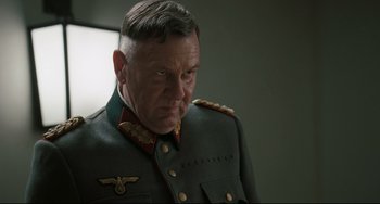 Movie still from “Valkyrie” (2008), directed by Bryan Singer – An older man in a military uniform looking to his left; Close Up shot, Over the shoulder angle