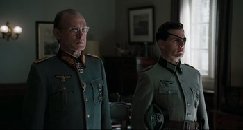 Movie still from “Valkyrie” (2008), directed by Bryan Singer – A man and a man in military uniforms; Medium shot, Over the shoulder angle