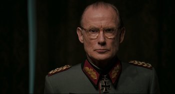 Movie still from “Valkyrie” (2008), directed by Bryan Singer – An older man in a military uniform wearing glasses; Close Up shot, Low angle