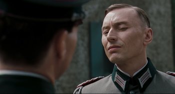 Movie still from “Valkyrie” (2008), directed by Bryan Singer – A man in a military uniform is talking to another man; Close Up shot, Low angle