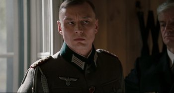 Movie still from “Valkyrie” (2008), directed by Bryan Singer – A person wearing a uniform; Close Up shot, Over the shoulder angle
