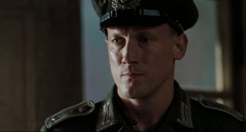 Movie still from “Valkyrie” (2008), directed by Bryan Singer – A man in a military uniform is looking at the camera; Close Up shot, Low angle