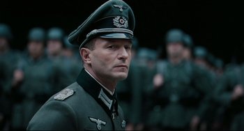 Movie still from “Valkyrie” (2008), directed by Bryan Singer – A person wearing a military uniform; Close Up shot, Low angle