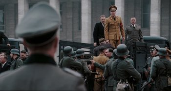 Movie still from “Valkyrie” (2008), directed by Bryan Singer – A group of men standing next to each other in uniforms; Wide shot, Low angle