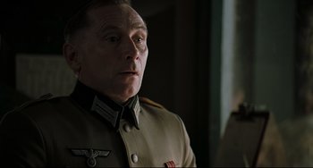 Movie still from “Valkyrie” (2008), directed by Bryan Singer – A man in a military uniform looking to his left; Close Up shot, Low angle