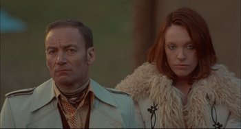 Movie still from “Velvet Goldmine” (1998), directed by Todd Haynes – A man and a woman standing next to each other; Close Up shot, Low angle