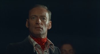Movie still from “Velvet Goldmine” (1998), directed by Todd Haynes – A person wearing a neck scarf; Close Up shot, Low angle