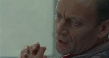 Movie still from “Velvet Goldmine” (1998), directed by Todd Haynes – A person looking out of a window; Close Up shot, Over the shoulder angle