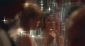 Movie still from “Velvet Goldmine” (1998), directed by Todd Haynes – Two women are looking at each other through a glass window; Close Up shot, Over the shoulder angle