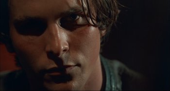Movie still from “Velvet Goldmine” (1998), directed by Todd Haynes – A man's face in a dark room; Close Up shot, Low angle