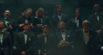 Movie still from “Velvet Goldmine” (1998), directed by Todd Haynes – A group of men in tuxedos are posing for a picture; Medium shot, High angle