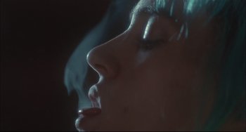 Movie still from “Velvet Goldmine” (1998), directed by Todd Haynes – A person smoking a cigarette; Extreme Close Up shot, Low angle