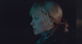 Movie still from “Velvet Goldmine” (1998), directed by Todd Haynes – A woman with blonde hair is looking to her left; Close Up shot, Low angle
