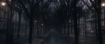 Movie still from “Venus in Fur” (2013), directed by Roman Polanski – A dark street with trees and benches on both sides of the street; Extreme Wide shot, High angle