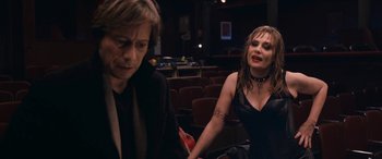Movie still from “Venus in Fur” (2013), directed by Roman Polanski – A woman in a black dress and a man in a black suit; Medium shot, Over the shoulder angle