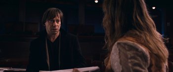 Movie still from “Venus in Fur” (2013), directed by Roman Polanski – A man and a woman are sitting at a table; Medium shot, Over the shoulder angle
