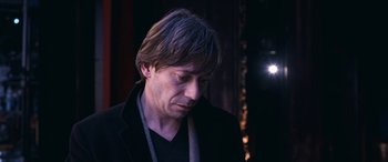 Movie still from “Venus in Fur” (2013), directed by Roman Polanski – A person wearing a black jacket; Close Up shot, Low angle