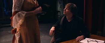 Movie still from “Venus in Fur” (2013), directed by Roman Polanski – A man and a woman sitting on the floor; Medium shot, Over the shoulder angle