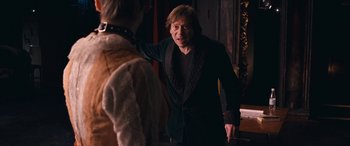 Movie still from “Venus in Fur” (2013), directed by Roman Polanski – A man standing next to another man in a room; Medium shot, Over the shoulder angle
