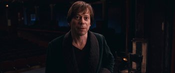 Movie still from “Venus in Fur” (2013), directed by Roman Polanski – A person wearing a jacket; Close Up shot, Low angle