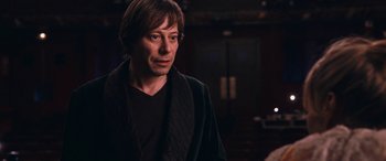 Movie still from “Venus in Fur” (2013), directed by Roman Polanski – A person wearing a black jacket; Medium shot, Over the shoulder angle