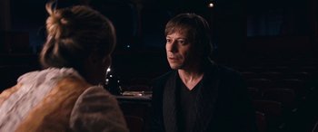 Movie still from “Venus in Fur” (2013), directed by Roman Polanski – A man and a woman are sitting at a table; Close Up shot, Over the shoulder angle