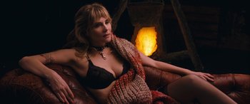 Movie still from “Venus in Fur” (2013), directed by Roman Polanski – A woman sitting in a chair wearing lingerie; Medium shot, High angle