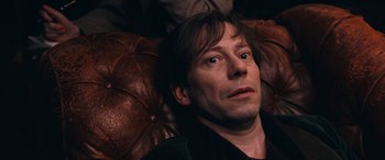 Movie still from “Venus in Fur” (2013), directed by Roman Polanski – A person laying on a couch; Close Up shot, Overhead angle