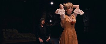 Movie still from “Venus in Fur” (2013), directed by Roman Polanski – A man and a woman are sitting on a stage; Medium shot, Over the shoulder angle