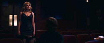 Movie still from “Venus in Fur” (2013), directed by Roman Polanski – Two women are standing in front of a man in a theater; Medium shot, Over the shoulder angle