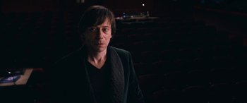 Movie still from “Venus in Fur” (2013), directed by Roman Polanski – A man standing in front of an audience in a theater; Medium shot, High angle