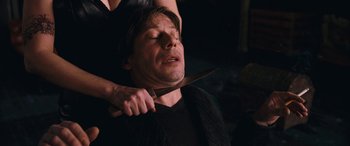 Movie still from “Venus in Fur” (2013), directed by Roman Polanski – A woman is holding a knife over a man's face; Close Up shot, High angle