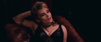 Movie still from “Venus in Fur” (2013), directed by Roman Polanski – A woman wearing a leather top and a leather choker; Close Up shot, High angle