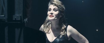 Movie still from “Venus in Fur” (2013), directed by Roman Polanski – A woman in a black dress looking up at something; Close Up shot, Over the shoulder angle