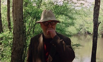 Movie still from “Vernon, Florida” (1981), directed by Errol Morris – An older man wearing a hat and a tie; Medium shot, Over the shoulder angle