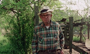 Movie still from “Vernon, Florida” (1981), directed by Errol Morris – An older man wearing a hat and glasses; Medium shot, Low angle