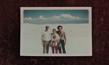 Movie still from “Vernon, Florida” (1981), directed by Errol Morris – Three people are standing in front of a desert; Wide shot, Overhead angle