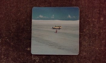 Movie still from “Vernon, Florida” (1981), directed by Errol Morris – A yellow truck is parked in the middle of the desert; Extreme Close Up shot, High angle