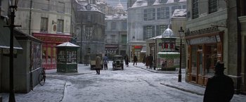 Movie still from “Victor/Victoria” (1982), directed by Blake Edwards – People walking down a snowy street in a city; Extreme Wide shot, High angle