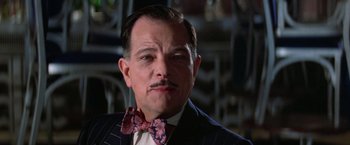Movie still from “Victor/Victoria” (1982), directed by Blake Edwards – A person wearing a suit and a bow tie; Close Up shot, Low angle