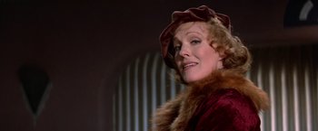 Movie still from “Victor/Victoria” (1982), directed by Blake Edwards – An older woman wearing a red dress and a hat; Close Up shot, Low angle