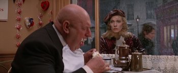 Movie still from “Victor/Victoria” (1982), directed by Blake Edwards – An older man and a woman sitting at a dinner table; Medium shot, Over the shoulder angle