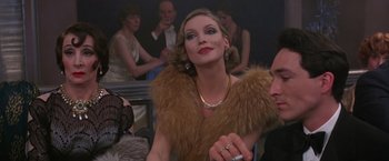 Movie still from “Victor/Victoria” (1982), directed by Blake Edwards – A woman wearing a fur coat and a fur stole; Close Up shot, Over the shoulder angle